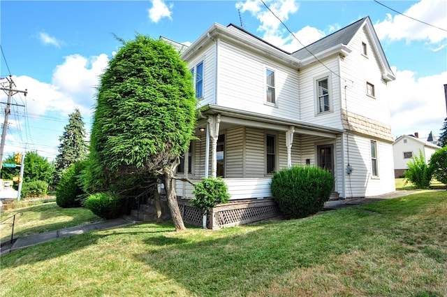 exterior space with covered porch and a lawn