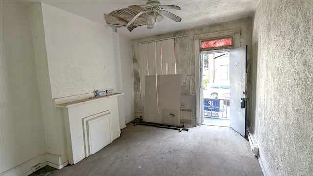 empty room with concrete floors and ceiling fan