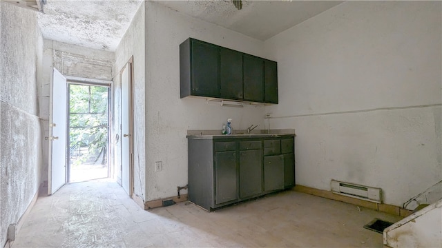 interior space featuring sink and a baseboard heating unit