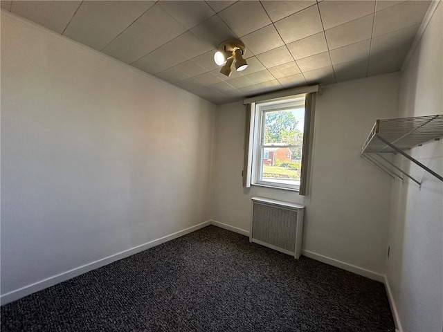 carpeted empty room featuring radiator