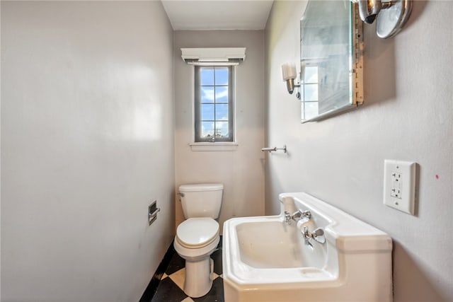 bathroom featuring tile patterned floors, sink, and toilet