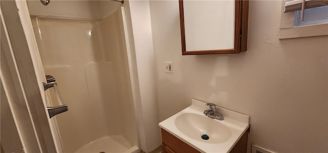 bathroom featuring vanity and walk in shower