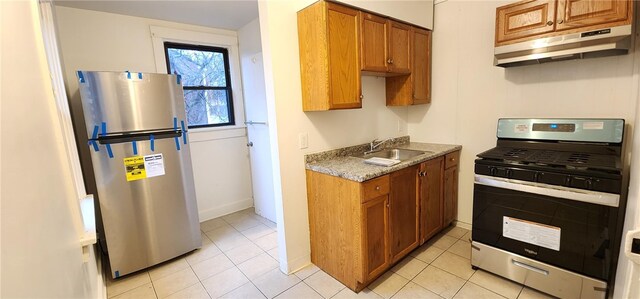 kitchen with light tile patterned flooring, sink, and appliances with stainless steel finishes