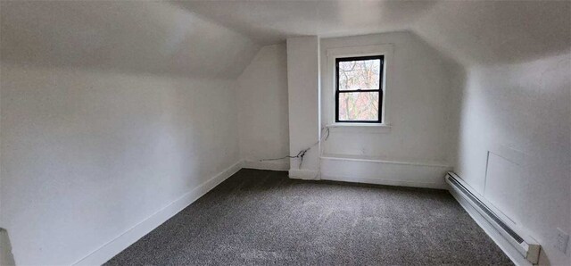 additional living space featuring carpet flooring, lofted ceiling, and a baseboard heating unit