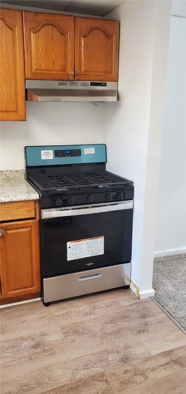 kitchen featuring light hardwood / wood-style floors and gas range