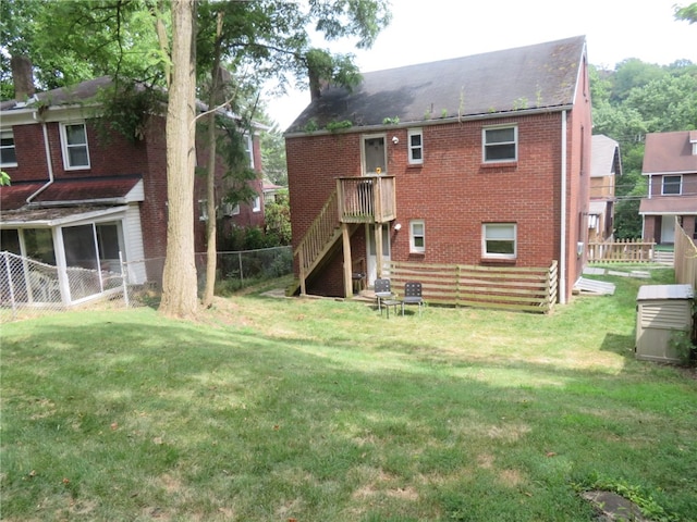 rear view of property featuring a yard