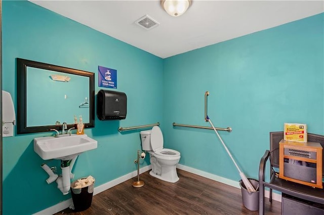 bathroom featuring sink, wood-type flooring, and toilet