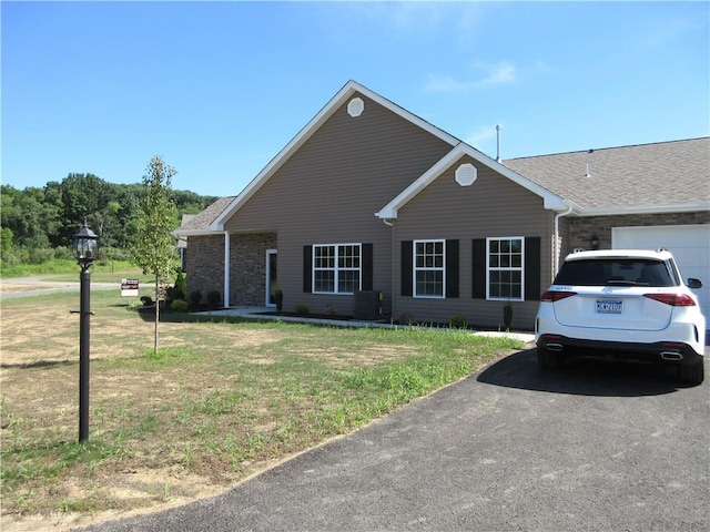 view of front facade with a garage and a front lawn