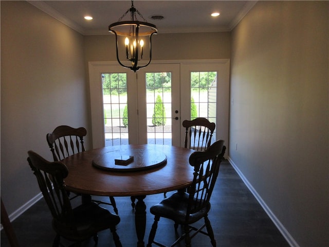 dining area with ornamental molding, french doors, dark hardwood / wood-style flooring, and a wealth of natural light