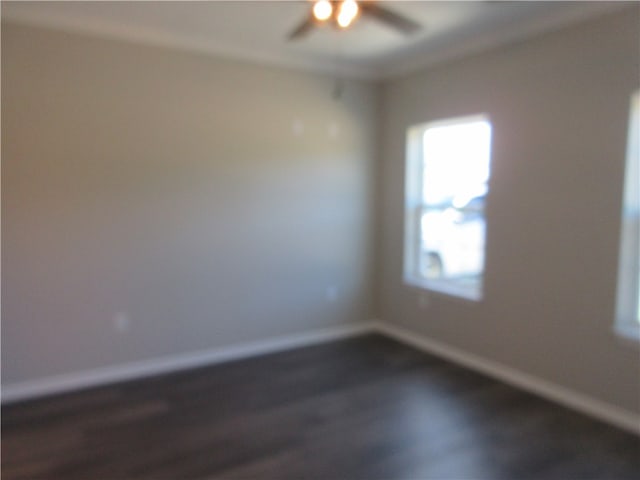 empty room featuring ceiling fan and dark hardwood / wood-style floors