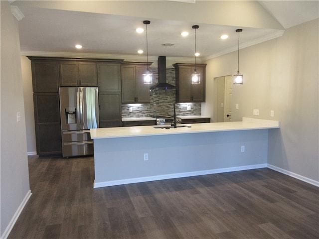 kitchen featuring wall chimney range hood, pendant lighting, dark hardwood / wood-style flooring, and stainless steel fridge with ice dispenser