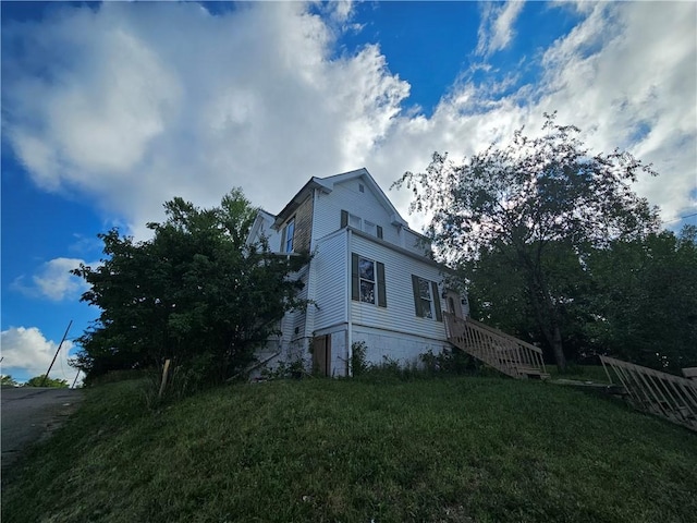 view of side of home with a lawn