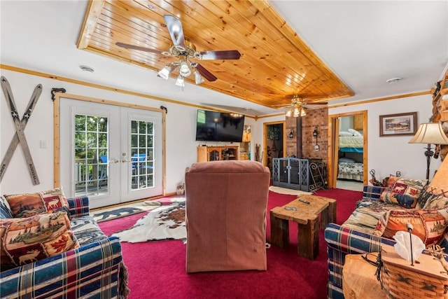 living room with ceiling fan, ornamental molding, french doors, and carpet floors