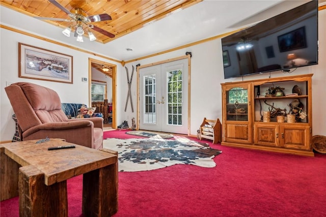 carpeted living room with ceiling fan, french doors, wood ceiling, and ornamental molding