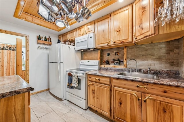 kitchen with white appliances, tasteful backsplash, sink, a raised ceiling, and light tile patterned floors