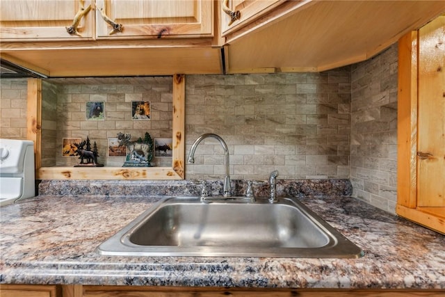 kitchen featuring tasteful backsplash and sink