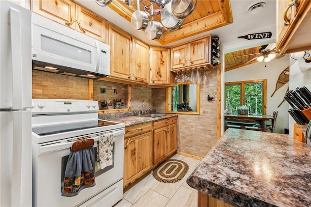 kitchen featuring ceiling fan, decorative backsplash, sink, white appliances, and light tile patterned floors