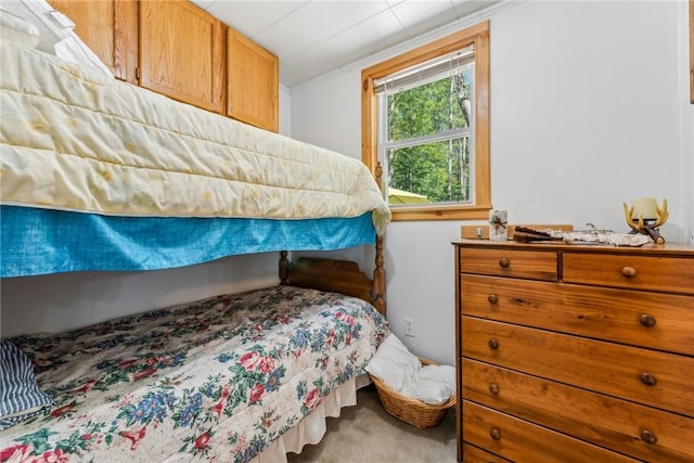 carpeted bedroom with ornamental molding