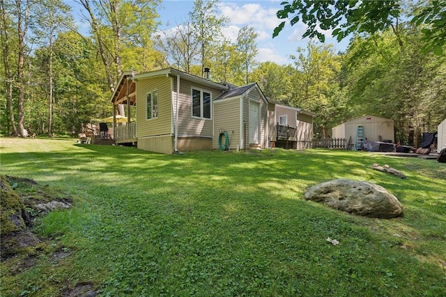 view of home's exterior featuring a deck and a lawn