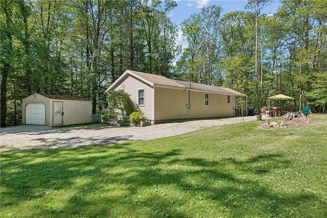 view of yard with a garage and a storage shed