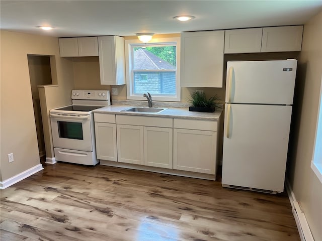 kitchen featuring sink, white appliances, light hardwood / wood-style floors, and white cabinets