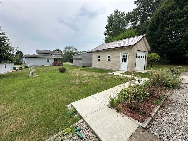 view of yard with a garage and an outdoor structure