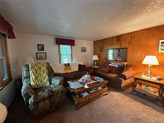 carpeted living room featuring wooden walls