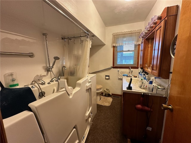 bathroom featuring toilet and vanity