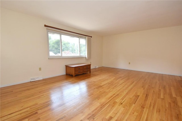 empty room with light hardwood / wood-style floors