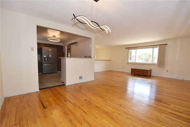 unfurnished living room featuring light hardwood / wood-style flooring