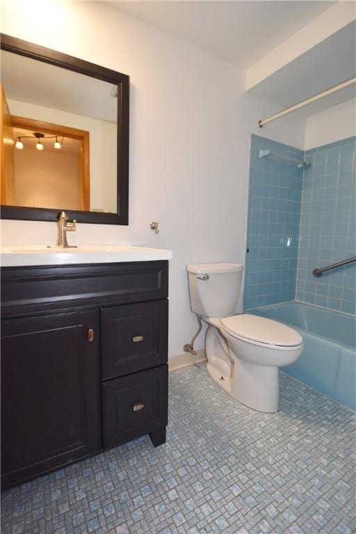 full bathroom featuring tile patterned floors, vanity, tiled shower / bath combo, and toilet