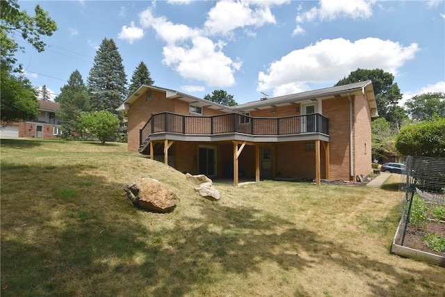 rear view of property featuring a yard and a wooden deck