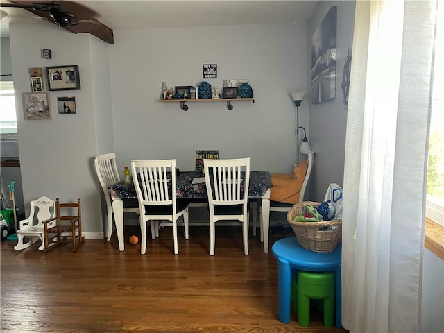 dining space with ceiling fan and dark hardwood / wood-style floors