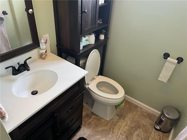 bathroom with vanity, tile patterned floors, and toilet