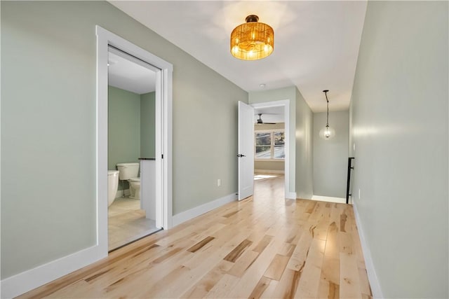 corridor with hardwood / wood-style flooring