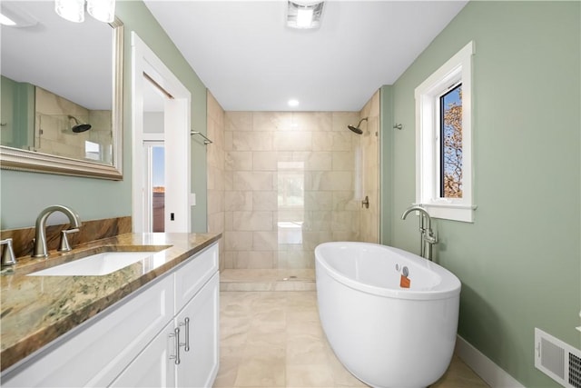 bathroom featuring vanity, tile patterned floors, and plus walk in shower