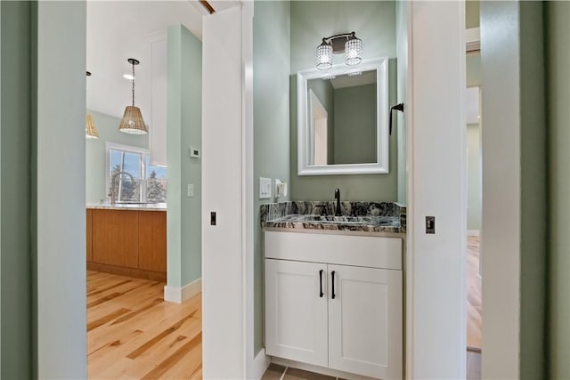 bathroom with vanity and hardwood / wood-style flooring