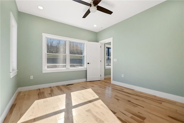 empty room featuring ceiling fan and light hardwood / wood-style floors