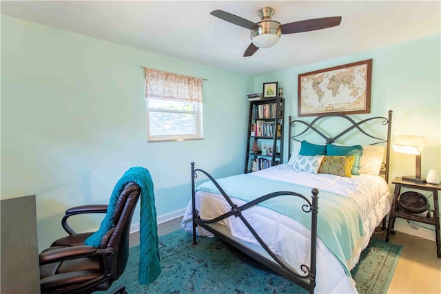 bedroom with ceiling fan and wood-type flooring