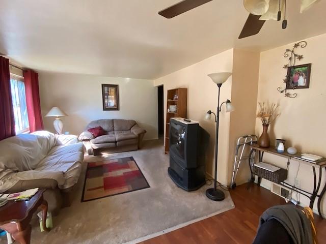 living room featuring ceiling fan and hardwood / wood-style flooring