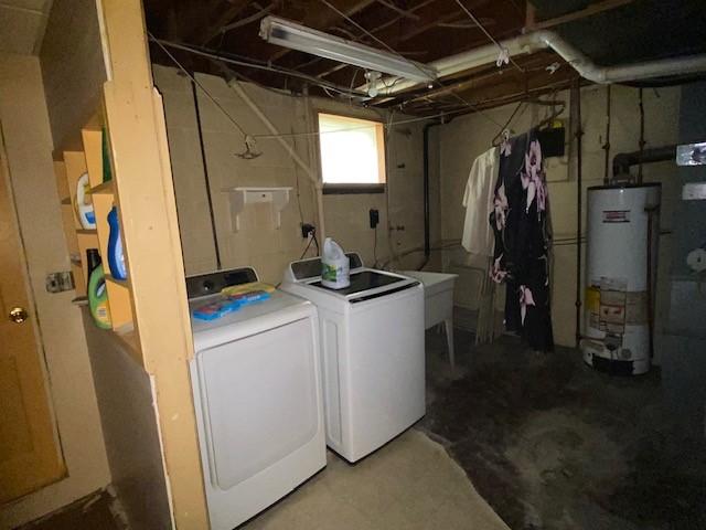 washroom with separate washer and dryer and gas water heater