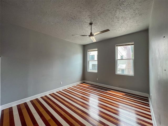 spare room featuring a textured ceiling, ceiling fan, and hardwood / wood-style floors