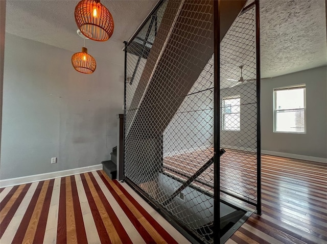 stairs featuring dark wood-type flooring and a textured ceiling