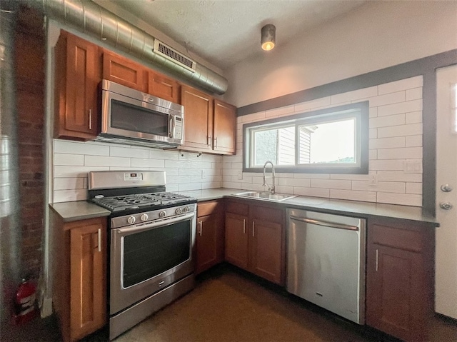 kitchen with sink, appliances with stainless steel finishes, and tasteful backsplash