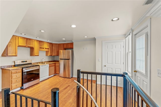 kitchen with sink, light hardwood / wood-style flooring, and stainless steel appliances