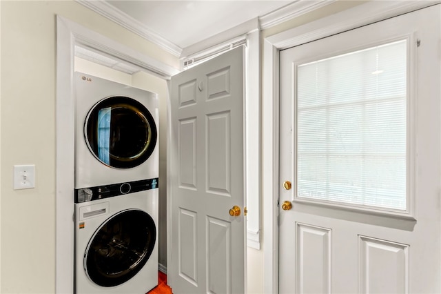 laundry room with stacked washer and dryer and ornamental molding