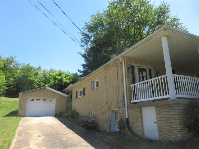 view of side of property with a porch, an outdoor structure, and a garage