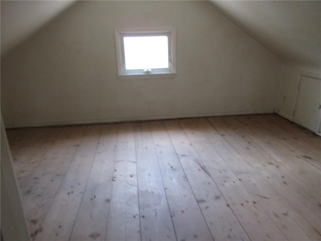 bonus room featuring light hardwood / wood-style floors and vaulted ceiling