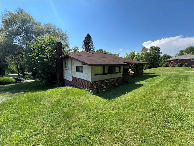 view of side of home featuring a yard