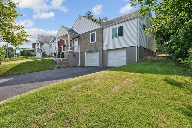 view of front of house with a garage and a front lawn